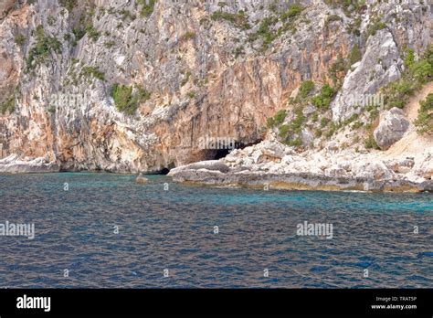 Cala Dei Gabbiani A Narrow Sandy Beach Below High Limestone Cliffs