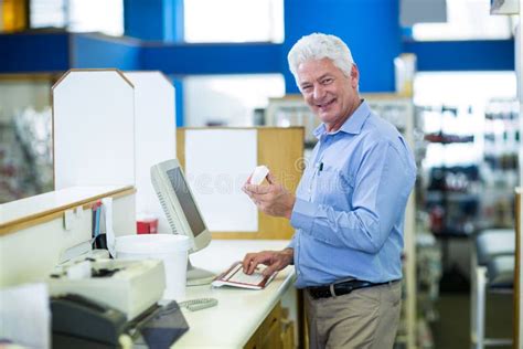 Pharmacist Making Prescription Record Through Computer In Pharmacy