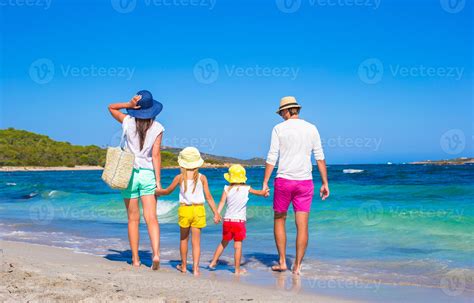 Happy family of four during beach vacation 18831361 Stock Photo at Vecteezy