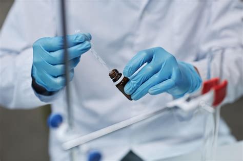 Premium Photo | Scientist holding dropper doing experiments with medicine in laboratory