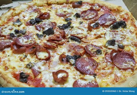 Delicious Freshly Made Pepperoni Pizza With Chunks Of Black Olives