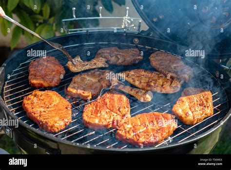 Steaks Cooking Over Flaming Grill Stock Photo Alamy