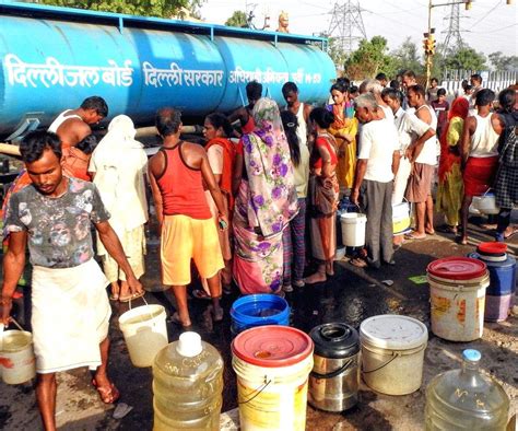 Residents Of Delhis Geeta Colony Fill Their Buckets From A Water