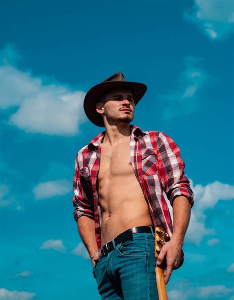 Premium Photo Cowboy Couture Portrait Of Young Man Wearing Cowboy Hat And Looking Up While