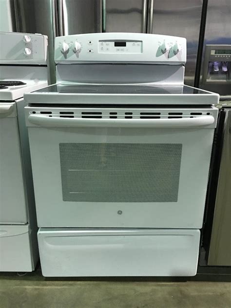 GE WHITE GLASS TOP 4 BURNER STOVE - Able Auctions