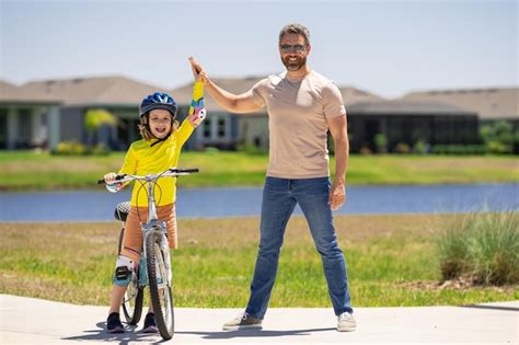 Premium Photo Father Support Son Happy Fathers Day Father And Son On The Bicycle Father And