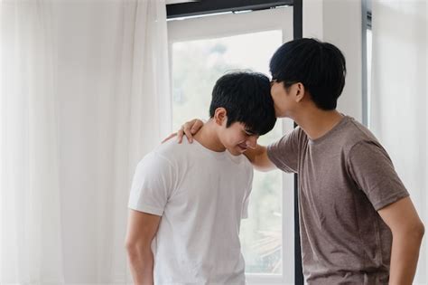 Free Photo Asian Gay Couple Standing And Hugging Near The Window At Home Young Asian Lgbtq