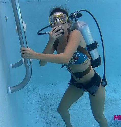 A Woman In A Swim Suit Holding Onto A Diving Device