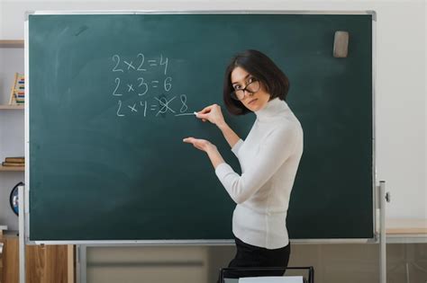 Free Photo Confident Young Female Teacher Wearing Glasses Standing In