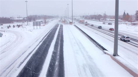 Team Of Huge Snowplows Clear Highway Freeway In A Blizzardduring A