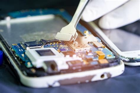 Premium Photo Technician Repairing Inside Of Mobile Phone By