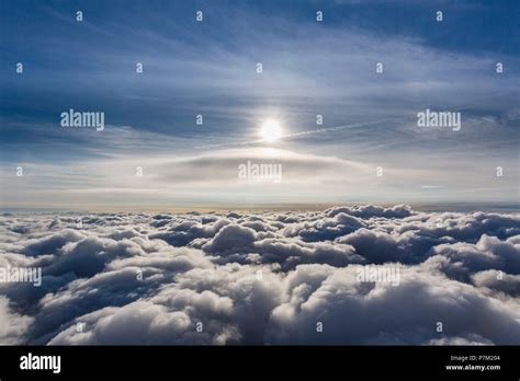 Lenticular cloud above the highest cloud layer, cumulus lenticularis, clouds and sun, cloud ...