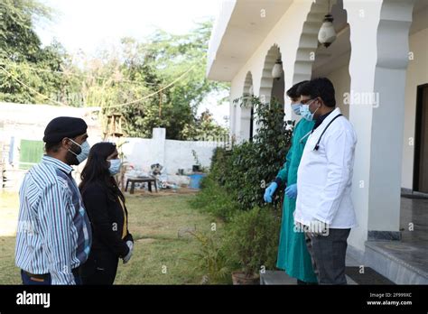 Closeup Of South Asian Healthcare Workers Informing Visitors Of Health