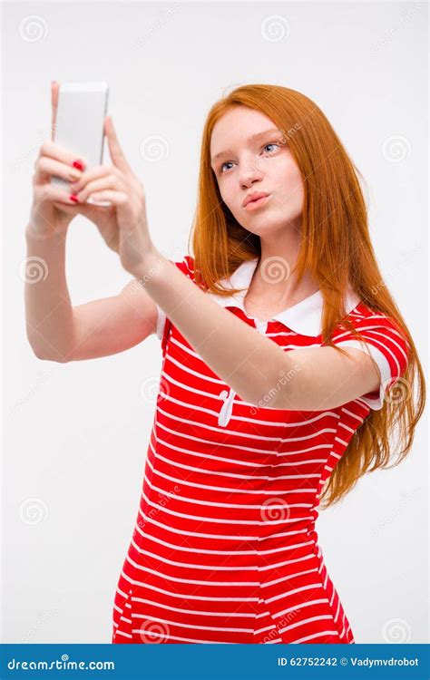 Young Beautiful Redhead Woman Taking Selfie And Making Duck Face Stock