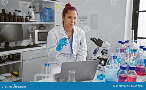 Portrait Of A Serious Young Redhead Woman Scientist Engrossed In Her Medical Research Thinking