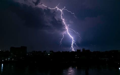 A Lightning Strike Over The City During Nighttime · Free Stock Photo