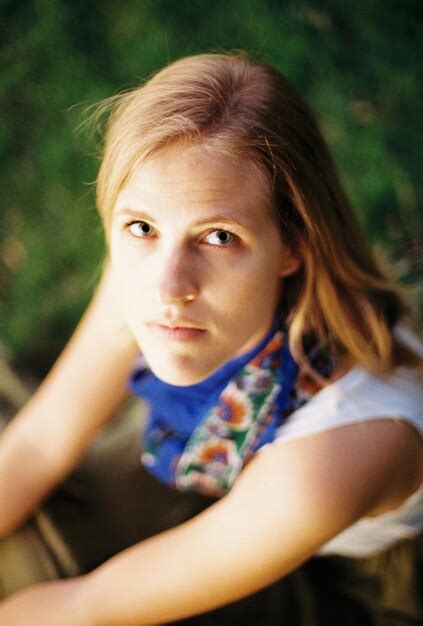 Premium Photo High Angle Portrait Of Serious Young Woman Sitting On Field