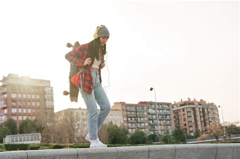 Premium Photo Latina Walking In The City With A Backpack And A Skateboard