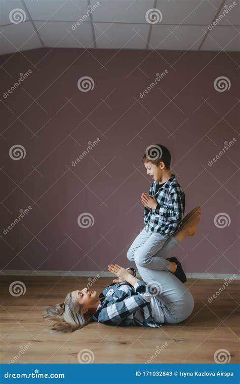 Young Sporty Mother And Son Doing Stretching Gymnastic Exercises