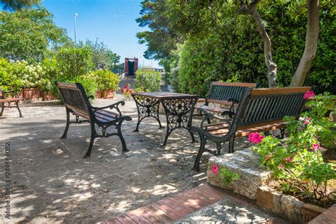 Vintage Italian style garden furniture set up on a terrace next to a ...