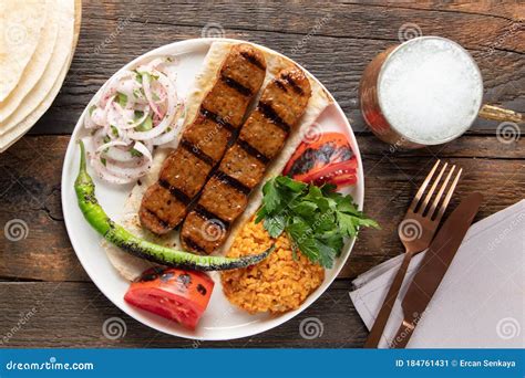 Turkish Adana Kebap With Rice Pilaf And Vegetables Served On A Plate