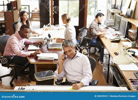 Interior Of Busy Architect S Office With Staff Working Stock Photo