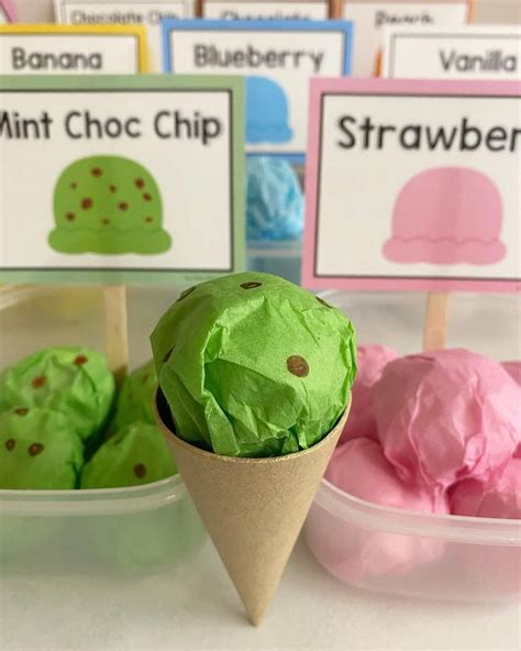 Three Ice Cream Cones With Green And Pink Paper In Them