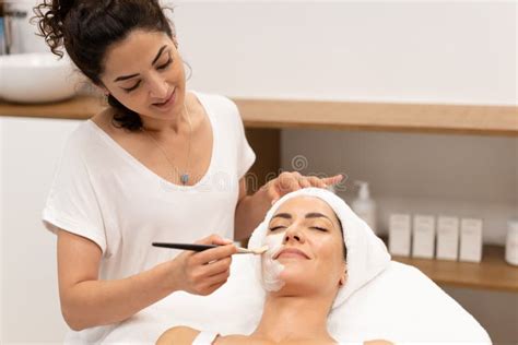 Beautician Applying Facial Mask On Client Stock Image Image Of