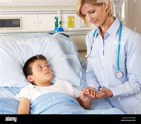 Doctor Visiting Child Patient On Ward Stock Photo Alamy