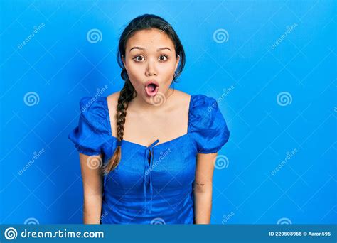 Young Hispanic Girl Wearing Casual Clothes Afraid And Shocked With