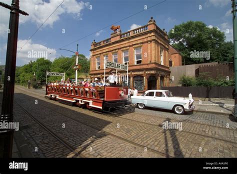 Open Top Tram Passing Red Lion Hotel At Crich Tramway Museum Stock