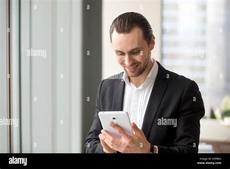 Smiling Happy Handsome Businessman Looking At Electronic Tablet Stock