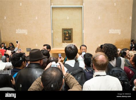 Crowds photographing the Mona Lisa at the Louvre museum, Paris, France ...