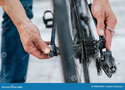 Close Up Of Mans Hands Fixing A Problem With Bike Tire Stock Photo