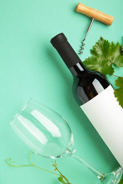 Premium Photo Wine Bottle With Wine Glass And Corkscrew Lying On Mint