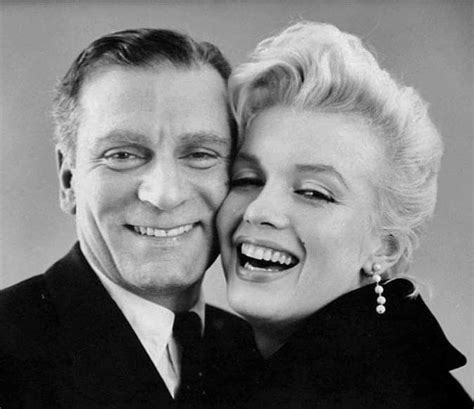 A Black And White Photo Of Two People Smiling