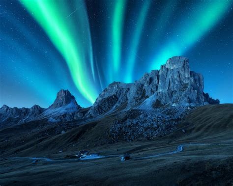 Premium Photo | Northern lights above mountains at night in Europe Aurora borealis Starry sky ...