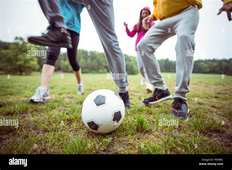 Friends Running Towards Football Stock Photo Alamy