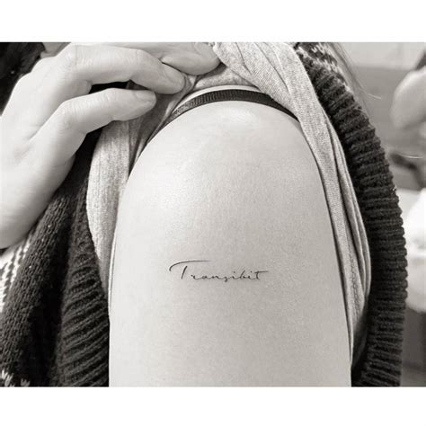 Transibit Lettering Tattoo Located On The Upper Arm