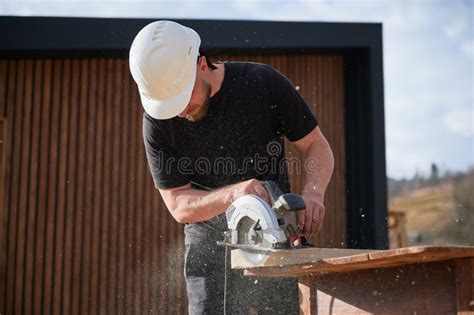 Carpenter Using Circular Saw For Cutting Joist For Building Wooden