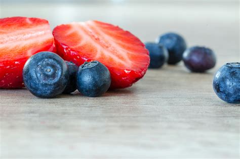 Burberry And Slice Strawberry On Brown Surface · Free Stock Photo