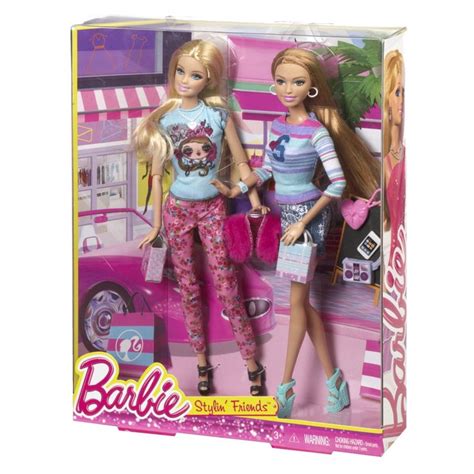 Two Barbie Dolls Standing Next To Each Other In Front Of A Pink Car