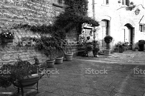 A Courtyard With Plant And Clay Pots Of A Stone House In A Medieval