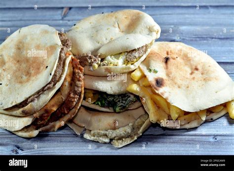 Traditional Egyptian breakfast street sandwiches of mashed fava beans ...