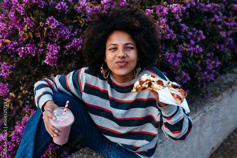 Woman eating street food Stock Photo | Adobe Stock