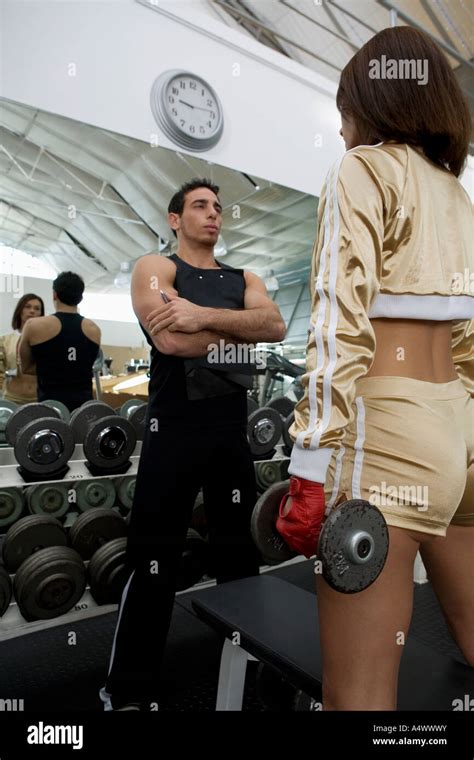 Personal Trainer Talking To Woman At A Gym Stock Photo Alamy