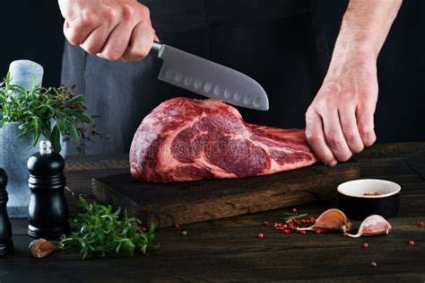 Chef Cutting Steak Beef Mans Hands Hold Raw Steak Tomahawk On Rustic