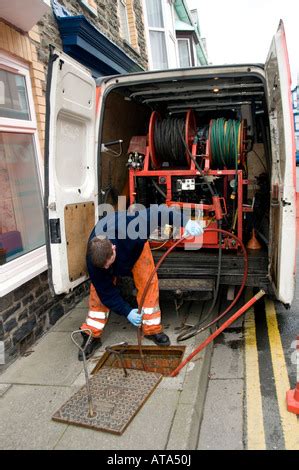 Dyno rod worker drain clearing blocked drain outside a terraced house - Dyno-rod is part of ...