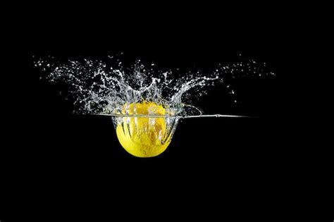 Premium Photo | Lemon in water splash