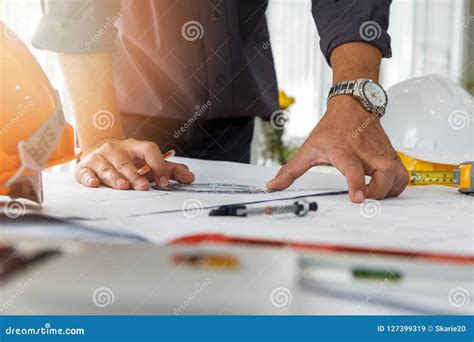 Architect Or Engineer Using Pencil And Protractor Working On Blueprint